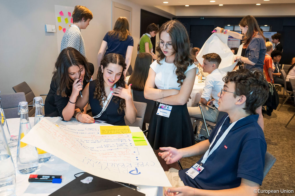 A young co-facilitator helping a group discussion