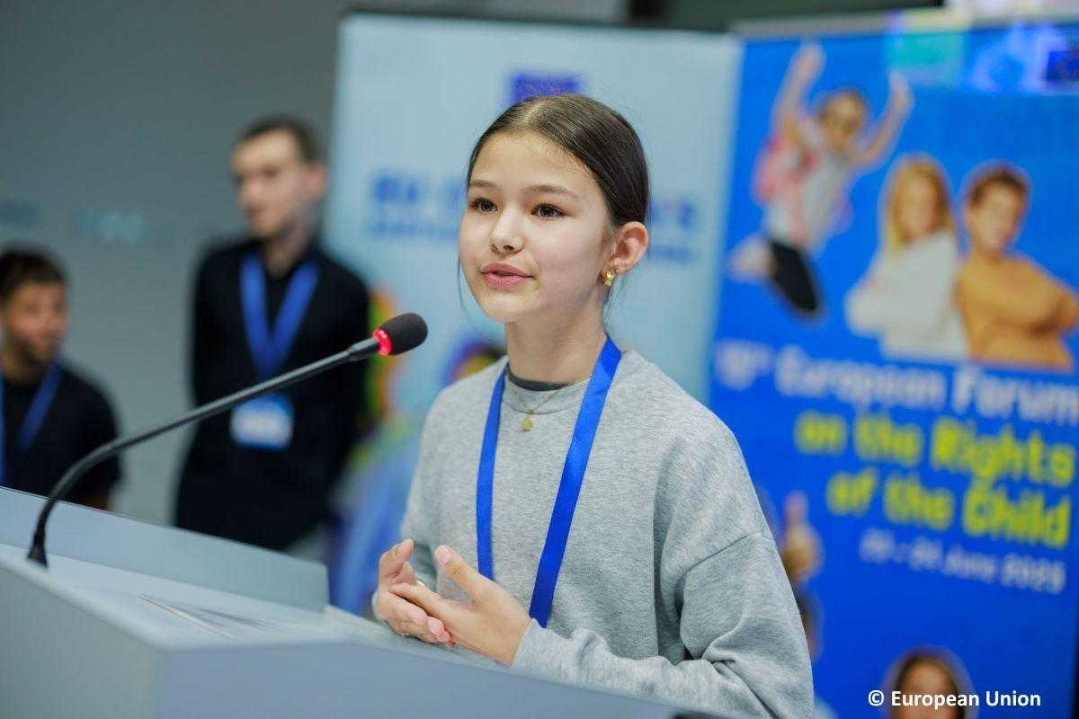 A young girl speaking into the microphone about the Call to Action