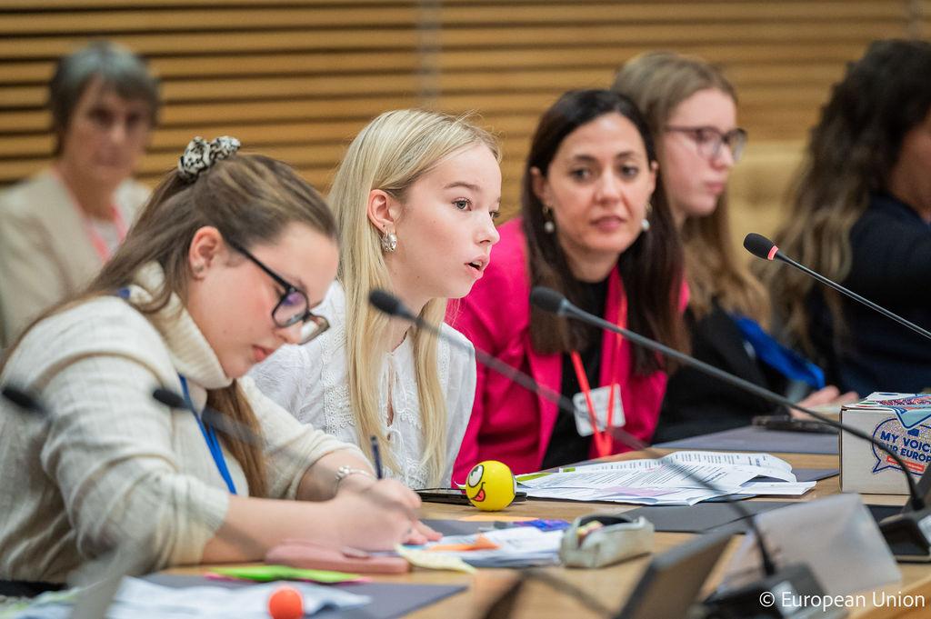 Young girl speaking into a microphone during the Board meeting