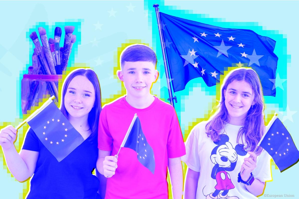 A young boy and two girls waving EU flags