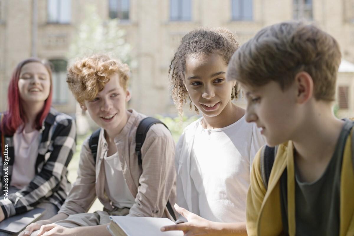 A group of young teens chatting together