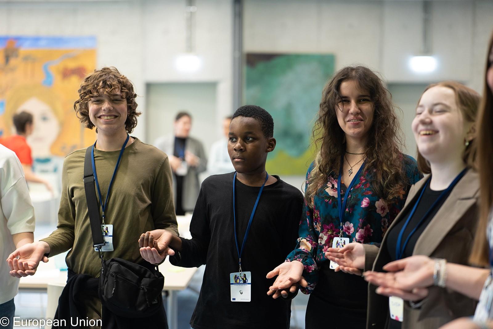 Four young people enjoying a warm-up activity during a workshop