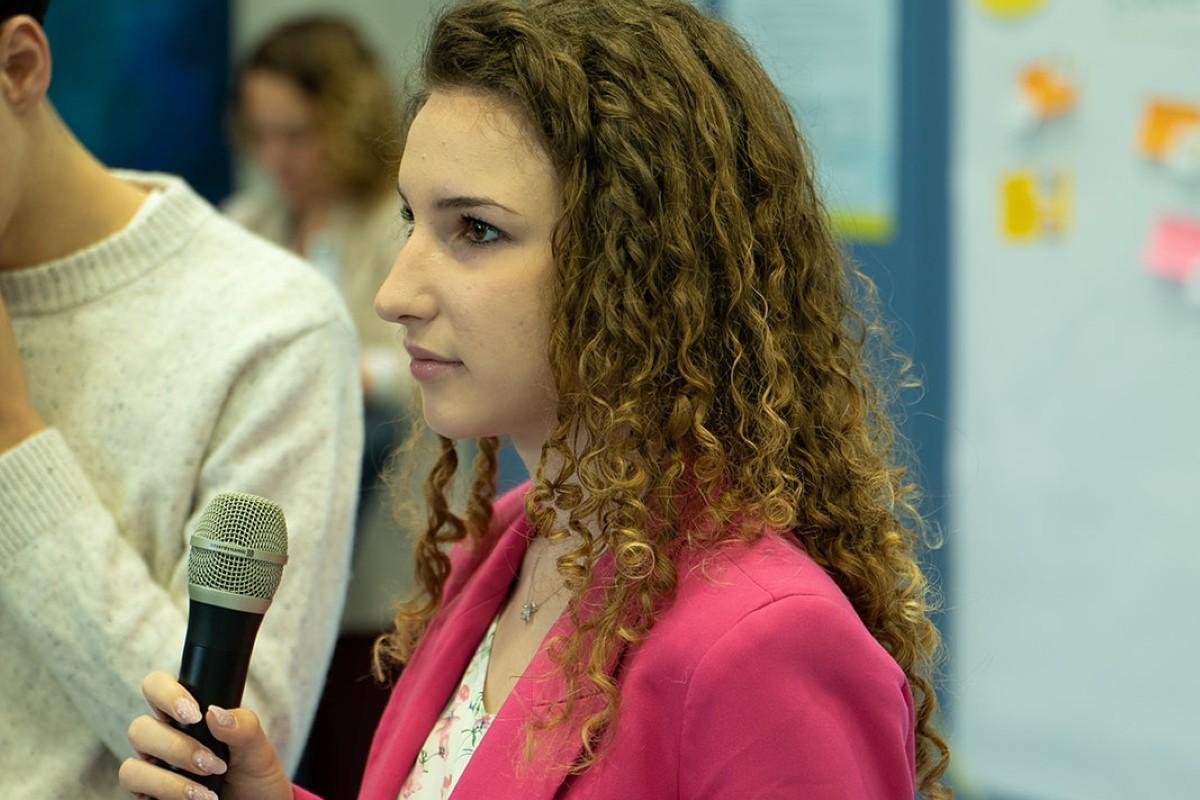Adriyana with a microphone in her hand