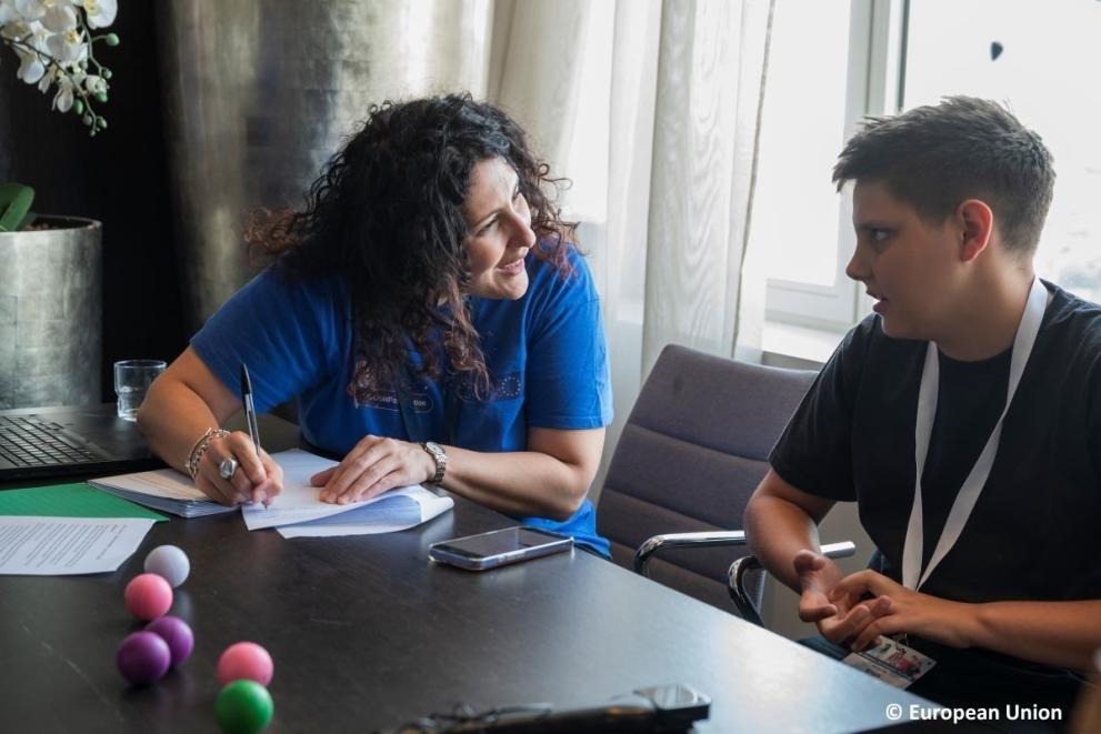 Boy helping test a mobile version during the General Assembly 2025.