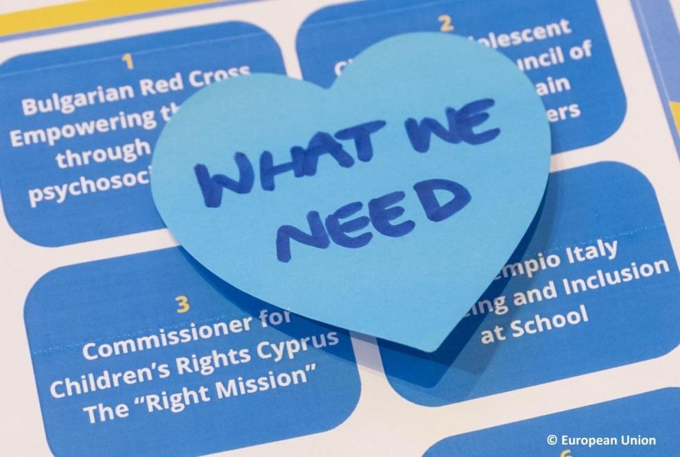 Heart-shaped note reading 'WHAT WE NEED' placed on a list of child-led initiatives at the General Assembly 2025.