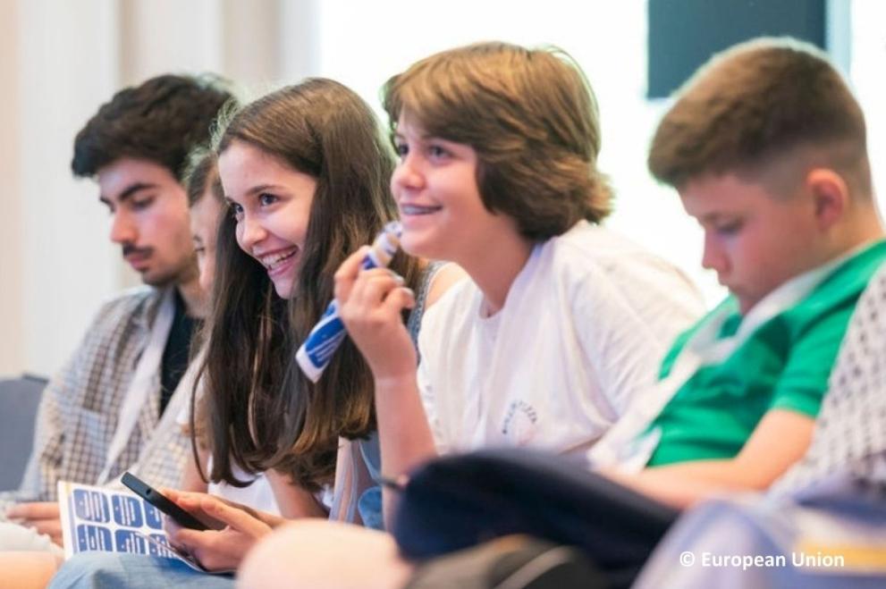 A group of four happy children doing a workshop together