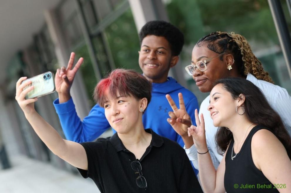 Four young conference participants taking a selfie